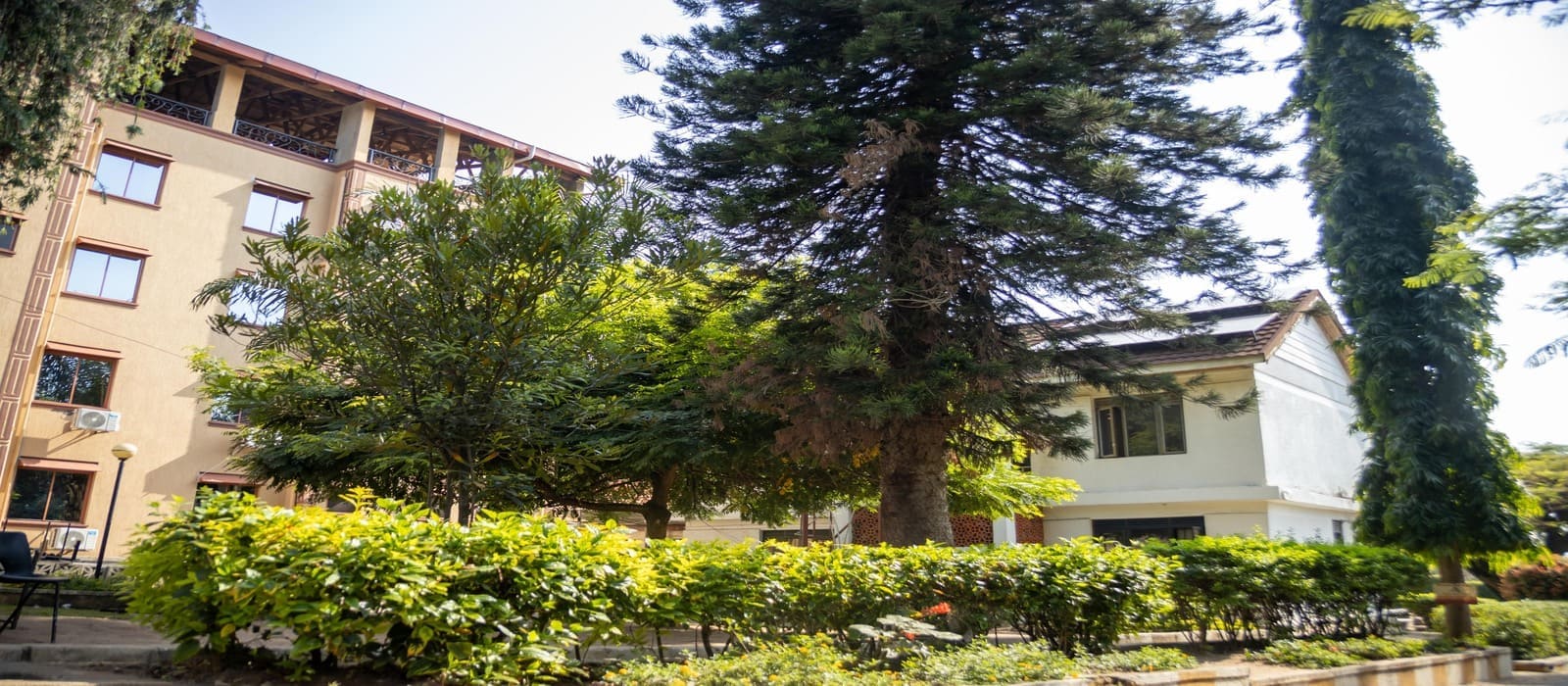 Lush courtyard view of Heritage Hotels Arua surrounded by greenery